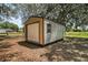View of the backyard shed with roll up door at 26200 Se Highway 42, Umatilla, FL 32784