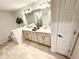 Bathroom featuring a double vanity, granite counters, modern fixtures, and tile floors at 3107 Ne 46Th Ave, Ocala, FL 34470