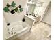 Bright bathroom featuring a garden tub, double vanity, granite counters, and tile floors at 3107 Ne 46Th Ave, Ocala, FL 34470