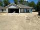 Unfinished single-story home with a two-car garage awaiting completion in a construction phase at 3107 Ne 46Th Ave, Ocala, FL 34470