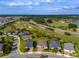 An aerial view highlighting the community's golf course, water feature, and well-maintained homes in a serene setting at 3587 Nw 55Th Cir, Ocala, FL 34482