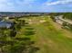 Aerial view shows the golf course landscape surrounded by residences in a picturesque and well-maintained neighborhood at 3587 Nw 55Th Cir, Ocala, FL 34482