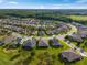 The aerial view shows a cul-de-sac of well-maintained homes with lush landscaping and mature trees at 3587 Nw 55Th Cir, Ocala, FL 34482