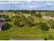 The aerial view of the backyard with a view of the golf course and surrounding neighborhood at 3587 Nw 55Th Cir, Ocala, FL 34482