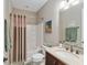 Well-lit bathroom features a shower-tub combo, vanity with a granite countertop, and neutral accents at 3587 Nw 55Th Cir, Ocala, FL 34482