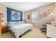 Bedroom with a blue quilt above the bed, a window, and decor at 3587 Nw 55Th Cir, Ocala, FL 34482