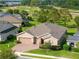 Charming single-story home with a brick driveway, attached two-car garage, and well-manicured lawn near the golf course at 3587 Nw 55Th Cir, Ocala, FL 34482