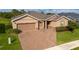 Beautiful single-story home featuring a brick driveway, a two-car garage, and well-maintained landscaping at 3587 Nw 55Th Cir, Ocala, FL 34482