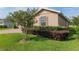 Landscaped yard with healthy green bushes and mulch surrounds a home with beautiful shutters at 3587 Nw 55Th Cir, Ocala, FL 34482