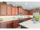 Bright kitchen with stainless steel appliances, granite countertops, undermount lighting, and custom wood cabinetry at 3587 Nw 55Th Cir, Ocala, FL 34482