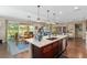 Open concept kitchen with a center island, stainless steel appliances, and views into the dining and living areas at 3587 Nw 55Th Cir, Ocala, FL 34482