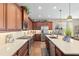 Charming kitchen features stainless appliances, granite counters, undermount lighting, and custom wood cabinetry at 3587 Nw 55Th Cir, Ocala, FL 34482
