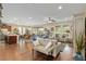 Expansive open-concept living area with hardwood floors connecting the kitchen and dining spaces at 3587 Nw 55Th Cir, Ocala, FL 34482