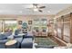 Bright living room featuring hardwood floors, large windows, and comfortable seating arrangements at 3587 Nw 55Th Cir, Ocala, FL 34482
