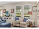 Comfortable living room with neutral tones, plush seating, and natural light from the large windows overlooking the outdoors at 3587 Nw 55Th Cir, Ocala, FL 34482