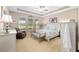 Light and airy main bedroom features trey ceilings, ceiling fan, and backyard views at 3587 Nw 55Th Cir, Ocala, FL 34482