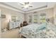 Relaxing main bedroom with trey ceilings, ceiling fan, and backyard views at 3587 Nw 55Th Cir, Ocala, FL 34482
