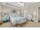 Well-lit main bedroom with trey ceilings, ceiling fan, and backyard views at 3587 Nw 55Th Cir, Ocala, FL 34482