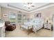 Light and airy main bedroom features trey ceilings, ceiling fan, and backyard views at 3587 Nw 55Th Cir, Ocala, FL 34482
