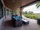 A covered patio provides a relaxing lounge area with wicker furniture and a scenic view of the community's greenery at 3587 Nw 55Th Cir, Ocala, FL 34482