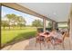 Screened patio features outdoor dining with a golf course view at 3587 Nw 55Th Cir, Ocala, FL 34482