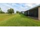 Home has a screened in porch with outdoor dining set, a manicured garden and a green lawn at 3587 Nw 55Th Cir, Ocala, FL 34482