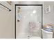 The shower showcases neutral tiling and glass doors, providing a clean and modern look at 3587 Nw 55Th Cir, Ocala, FL 34482