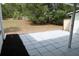 A home featuring a spacious tiled back patio and a well-maintained lawn at 3807 Sw 143Rd Lane Rd, Ocala, FL 34473