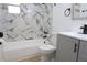Bathroom featuring marble-look tile shower, bathtub, toilet, and modern vanity with black fixtures at 3807 Sw 143Rd Lane Rd, Ocala, FL 34473