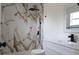Bathroom featuring a beautifully tiled shower, modern fixtures, a new vanity, and ample natural light at 3807 Sw 143Rd Lane Rd, Ocala, FL 34473