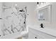 Updated bathroom showcasing elegant marble tile, new vanity, and modern fixtures at 3807 Sw 143Rd Lane Rd, Ocala, FL 34473