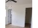 Bright bedroom featuring neutral walls, light-colored floors, and multiple doorways at 3807 Sw 143Rd Lane Rd, Ocala, FL 34473