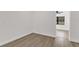 Clean bedroom design with light wood-look floors, neutral paint, and an open doorway at 3807 Sw 143Rd Lane Rd, Ocala, FL 34473
