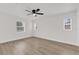 Bedroom with hardwood floors and two windows at 3807 Sw 143Rd Lane Rd, Ocala, FL 34473