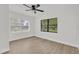 Bright bedroom featuring updated floors, ceiling fan, and natural light from large windows at 3807 Sw 143Rd Lane Rd, Ocala, FL 34473
