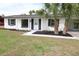 Charming single-story home featuring an open carport, contrasted by fresh plantings and black window shutters at 3807 Sw 143Rd Lane Rd, Ocala, FL 34473