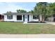 Charming single-story home with a well-manicured lawn, complemented by fresh plantings and black shutters at 3807 Sw 143Rd Lane Rd, Ocala, FL 34473