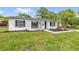 Charming single-story home featuring a fresh white exterior, black shutters, and a well-manicured lawn at 3807 Sw 143Rd Lane Rd, Ocala, FL 34473