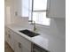Close-up of quartz countertops, stainless-steel sink, and modern fixtures in this updated kitchen space at 3807 Sw 143Rd Lane Rd, Ocala, FL 34473