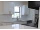 Beautiful, modern kitchen with white cabinets, gold hardware, and subway tile backsplash, freshly updated at 3807 Sw 143Rd Lane Rd, Ocala, FL 34473