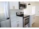 Bright kitchen featuring stainless steel appliances, white cabinets with gold hardware, and light countertops at 3807 Sw 143Rd Lane Rd, Ocala, FL 34473