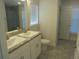 Bathroom features double sinks, a granite countertop, white cabinetry, tile floors and a separate glass enclosed shower at 4373 Ne 31St St, Ocala, FL 34470
