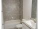 Bathroom with tub, shower, single sink vanity, granite countertop, tiled walls and brushed nickel fixtures at 4373 Ne 31St St, Ocala, FL 34470