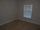 Bedroom featuring light wood floors, white walls, and a window with blinds at 4373 Ne 31St St, Ocala, FL 34470