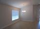 Open dining room area featuring wood floors, a window and modern chandelier at 4373 Ne 31St St, Ocala, FL 34470