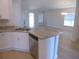 Open concept kitchen with granite countertops, stainless steel appliances, and a view of the living room at 4373 Ne 31St St, Ocala, FL 34470
