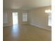 Spacious living room with light wood floors, neutral walls and abundant natural light from a sliding glass door at 4373 Ne 31St St, Ocala, FL 34470