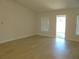 Bright living room featuring light wood floors, neutral walls and direct access to the outdoors at 4373 Ne 31St St, Ocala, FL 34470