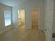 Bright room with light hardwood flooring, leading to en-suite bath and closet at 4373 Ne 31St St, Ocala, FL 34470