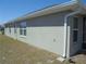 Neutral-toned single story home with white trim, gutters and nicely manicured lawn at 4373 Ne 31St St, Ocala, FL 34470